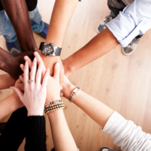 Hands piled together in a show of support